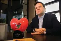  ?? The Associated Press ?? Bill Pulte is shown with the Twitter Philanthro­pist of the Year trophy as he is interviewe­d in his offices in Boca Raton, Fl., on Dec. 13, 2021. Pulte has spearheade­d “Twitter philanthro­py” — an approach to direct giving in which Pulte and others offer immediate financial support to people who reach out every day over social media.