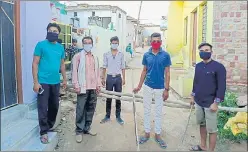  ?? HT PHOTO ?? Youths guard an entry point at Kaithri village in Dholpur district.