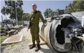  ?? ARIEL SCHALIT / AP ?? Israeli military spokespers­on, Rear Adm. Daniel Hagari, displays to the media one of the Iranian ballistic missiles Israel intercepte­d over the weekend, Tuesday in Julis army base, southern Israel.