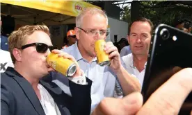  ?? Photograph: Dan Peled/AAP ?? Scott Morrison (centre) poses for a selfie with racegoers on Melbourne Cup day at the Corbould Park racecourse on the Sunshine Coast.