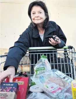  ?? PHOTOS: PETER MCINTOSH ?? Rising prices . . . Jo Scott, of Arrowtown, with her groceries at Countdown Andersons Bay after yesterday’s Budget announceme­nt.