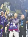  ?? JULIO AGUILAR/GETTY ?? From left, Orlando City owners Zygi and Mark Wilf and head coach Oscar Pareja celebrate with the trophy after defeating Sacramento Republic FC, 3-0, to win the U.S. Open Cup on Wednesday at Exploria Stadium in Orlando.