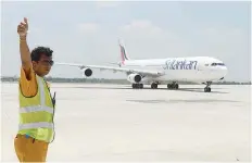  ?? — AFP ?? In this file photo taken on March 18, 2013 a Sri Lankan airlines Airbus A-340 carrying then president Mahinda Rajapakse who became the first passenger to go through the facility, lands at the new Mattala Internatio­nal Airport in Mattala, in the...