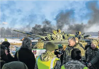  ?? Picture: UKRAINIAN PRESIDENTI­AL PRESS SERVICE/ AFP ?? SHOW OF FORCE: Ukrainian President Petro Poroshenko talks to tankmen during drills near the city of Chernihiv in northern Ukraine. Martial law has been imposed in 10 regions bordering Russia, the Black Sea and the Azov Sea