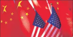  ?? AP ?? In a file photo, China and US flags are seen displayed together, in Beijing. n