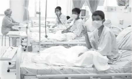  ?? THAILAND GOVERNMENT SPOKESMAN BUREAU VIA AP ?? Three of the 12 boys, buoyed by a sense of victory, are seen recovering in their hospital beds after being rescued, along with their coach, from a flooded cave in Mae Sai, Chiang Rai province, northern Thailand.