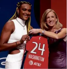  ?? SARAH STIER/GETTY IMAGES ?? UConn’s Aaliyah Edwards (left) received a new jersey after the Washington Mystics drafted her at No. 6.