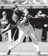  ?? Associated Press ?? n Texas Rangers’ Adrian Beltre hits March 6 during the first inning of a spring training game against the Seattle Mariners in Peoria, Ariz.