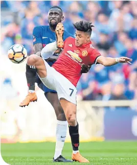  ??  ?? United’s Alexis Sanchez is challenged by Antonio Rudiger