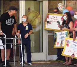  ?? Brian A. Pounds / Hearst Connecticu­t Media ?? A Gaylord Specialty Care staff member was on hand for the discharge of a patient after a four-month bout with COVID-19 in 2020. The Wallingfor­d rehabilita­ion hospital’s staff had to deal with the stresses of patient care during the pandemic, with as many as 30 or more patients in recovery from COVID-19 at varying points.