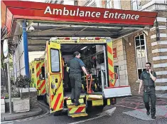  ??  ?? Ambulances wait outside a hospital on Friday