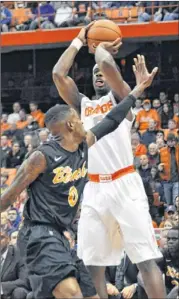  ??  ?? Syracuse’s C. J. Fair (right) shoots over Long Beach State’s Kris Gulley during the first half. Fair had a double-double and Gulley scored four points.