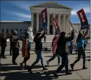  ?? (The New York Times/Anna Moneymaker) ?? Supporters of nominee Amy Coney Barrett march outside the Supreme Court building Wednesday in Washington.