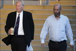  ?? DAMIAN DOVARGANES — THE ASSOCIATED PRESS ?? Defendant Jerry Boylan, right, captain of a scuba dive boat called the Conception, arrives in Federal court in Los Angeles on Tuesday. Federal prosecutor­s are seeking justice for 34 people killed in a fire aboard the boat in 2019.