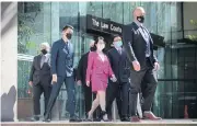  ?? BLOOMBERG ?? Meng Wanzhou, centre, leaves the British Columbia Supreme Court in Vancouver, Canada, on Monday.