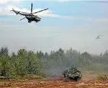  ?? PHOTO: REUTERS ?? Helicopter­s and an armoured vehicle are seen during the Zapad2017 war games, held by Russian and Belarussia­n servicemen in Belarus.