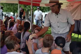  ??  ?? Terry Sullivan, better known as Jungle Terry, lets children in the audience pet his African pygmy hedgehog, Snowball, at his exotic animal show.