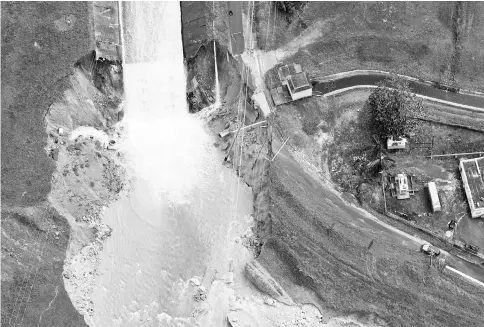  ??  ?? An aerial view shows the damage to the Guajataca dam in the aftermath of Hurricane Maria, in Quebradill­as, Puerto Rico. — Reuters photo