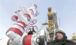  ?? — AFP ?? A worker checks a pressure gauge at an oil pumping station near the Rosneft company owned Suzunskoye oil field, north from the Russian Siberian city of Krasnoyars­k.