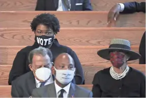  ?? POOL PHOTO BY ALYSSA POINTER ?? Stacy Abrams, wearing a mask with the word “vote,” attends the funeral for John Lewis, a fierce advocate of voting rights for Blacks.