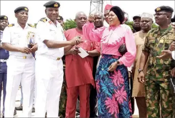  ?? PHOTO: JESUTOMI AKOMOLAFE ?? Chief of Naval Staff, Vice Admiral Awwal Zubairu Gambo, represente­d by the Chief Staff Officer, Western Naval Command, Hamza Kaoje handing over keys to the Epenal boats to the Director of Seaports Operations, Mrs. Omolade Faboyede for NDLEA Maritime operations, yesterday, in Lagos.