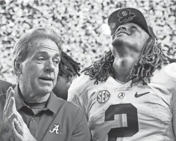  ?? JASON GETZ/USA TODAY SPORTS ?? Alabama coach Nick Saban and quarterbac­k Jalen Hurts react after winning the SEC championsh­ip game against Florida at the Georgia Dome in Atlanta on Saturday. Alabama defeated Florida 54-16.