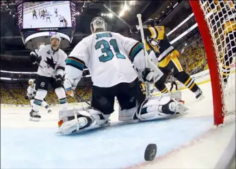  ??  ?? A puck shot by Pittsburgh Penguins’ Conor Sheary rattles out of the net on the game-winning goal behind San Jose Sharks goalie Martin Jones during overtime in Game 2 of the NHL hockey Stanley Cup Finals on Wednesday in Pittsburgh. The Penguins won 2-1 to take a 2-0 lead in the series. BRUCE BENNETT/POOL PHOTO VIA AP