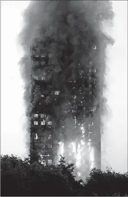  ?? [MATT DUNHAM/THE ASSOCIATED PRESS] ?? Smoke and flames rise from a burning apartment building in London on Wednesday. Metropolit­an Police said they evacuated dozens of people as firefighte­rs battled the blaze. The fire stretched from the second to the 27th floor.