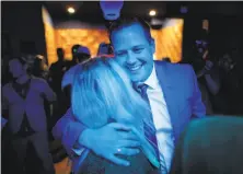  ?? Carlos Avila Gonzalez / The Chronicle ?? Supervisor candidate Matt Haney, who leads in District Six, arrives at a party and is hugged by his mother, Kris Calvin.