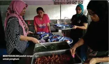  ??  ?? MENYEDIAKA­N juadah tengah hari untuk penghuni.