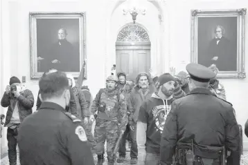  ?? ERIN SCHAFF/THE NEW YORK TIMES ?? A mob of Trump-supporters riot inside the Capitol in Washington on Wednesday.