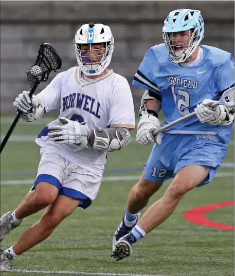  ?? MATT STONE — BOSTON HERALD ?? Norwell’s Nolan Petrucelli, left, takes the ball as Medfield’s Kevin Arthur gives chase during a boys lacrosse game last June. Both teams are expected to be strong again.