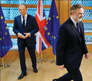 ??  ?? We’re off: The UK’s ambassador to the EU Tim Barrow walks away after handing the PM’s Article 50 letter to President of the European Council Donald Tusk