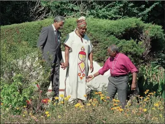  ?? ?? Tutu (right) leads the way for Nelson Mandela and Madikizela-Mandela on Feb. 12, 1990, into the garden at his Cape Town, South Africa, residence. (File Photo/AP/Udo Weitz)