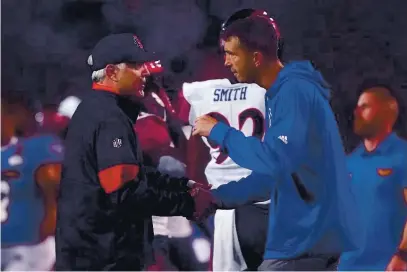  ?? TONY AVELAR — BAY AREA NEWS GROUP ?? San Jose State head coach Brent Brennan, right, shakes hands with San Diego State head coach Rocky Long, left, after a Mountain West Conference football game at Spartan Stadium in San Jose on Oct. 19, 2019. Brennan, right, learned the Spartans 8-game schedule for the 2020 season on Thursday.