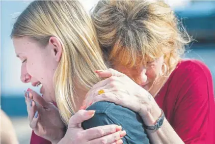  ?? Stuart Villanueva, The Galveston County Daily News ?? Susan Davidson, right, hugs her daughter Dakota Shrader, a student at Santa Fe High School in Santa Fe, Texas, after an armed 17-year-old male opened fire, killing 10 people, most of them students.