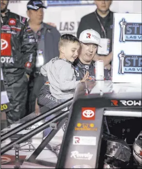  ?? K.M. Cannon Las Vegas Review-Journal @KMCannonPh­oto ?? Kyle Busch and his son, Brexton, 4, apply the winner sticker to his truck after taking first in last year’s Strat 200 NASCAR Truck Series race at Las Vegas Motor Speedway.