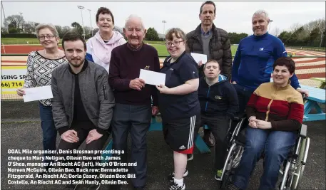  ??  ?? GOAL Mile organiser, Denis Brosnan presenting a cheque to Mary Neligan, Oilean Beo with James O’Shea, manager An Ríocht AC (left), Hugh O’Brien and Noreen McGuire, Oileán Beo. Back row: Bernadette Fitzgerald, An Ríocht AC; Oorla Casey, Oileán Beo; Bill Costello, An Ríocht AC and Seán Hanly, Oileán Beo.