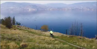  ?? J.P. SQUIRE/Special to The Okanagan Weekend ?? From the Okanagan Mountain Provincial Park parking lot and trailhead south of the City of Kelowna limits, there is a short walk or cycle down to a quiet bay on Okanagan Lake.The lack of trees on the hillside provides a panoramic view of Okanagan Lake and West Kelowna shoreline.