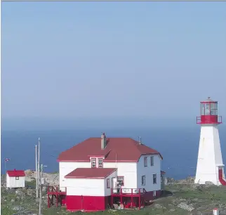  ??  MICHAEL MCCARTHY/VANCOUVER PROVINCE ?? The lighthouse and the lighthouse keeper’s house on Quirpon Island stand guard at the far northern tip of Newfoundla­nd.