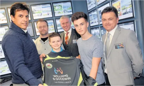  ??  ?? Chris Coleman opens Williams & Goodwin’s new office in Bangor on Friday and presents the new kit to shirt to Joe
Williams of Llanfairpw­ll’s under-14s team. Also in the picture are Martin Jones, manager and Sam Goodwin