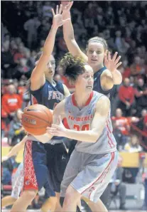  ?? MARLA BROSE/JOURNAL ?? UNM’s Sara Halasz looks to pass the ball while being defended by two Fresno State players during Saturday’s game in the Pit.