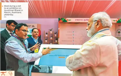  ?? PTI ?? Modi during a visit to an exhibition on Ayushman Bharat in Ranchi, Jharkhand, yesterday.