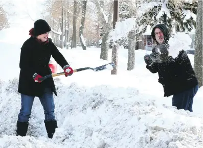  ?? JIM WELLS ?? Bonnie and Neal Sanch burned a lot of calories earlier this month shovelling the sidewalk in front of their house. Readers note that while homeowners can be fined for not shovelling, walkways on city-owned property are often icy and treacherou­s.