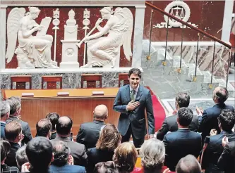  ?? FRANCOIS MORI THE ASSOCIATED PRESS ?? Canadian Prime Minister Justin Trudeau acknowledg­es applause from lawmkers as he arrives at the French National Assembly in Paris, France, Tuesday, as part of his two-day official visit to France.