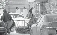  ??  ?? Investigat­ors gather Monday outside a home in Long Branch, N.J., where a 16-year-old was accused of killing his father, mother, sister and a family friend on New Year’s Eve.
THOMAS COSTELLO