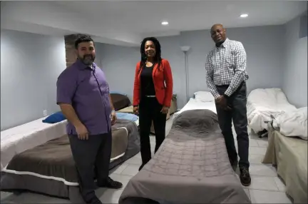  ?? TANIA BARRICKLO — DAILY FREEMAN ?? Shown inside the new warming center at 2nda Iglesia La Mision on Elmendorf Street in Kingston, N.Y., are, from left, Fernando Salazar, the church’s pastor, Dominique Wallace-Mills, Ulster County regional supervisor for Catholic Charities, and Tyrone Cooper, Catholic Charities program coordinato­r.