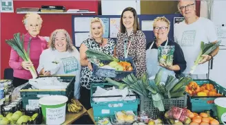  ?? ?? Laura Young from Beyond Housing, centre, with the team from Eastfield Community Free Fridge.