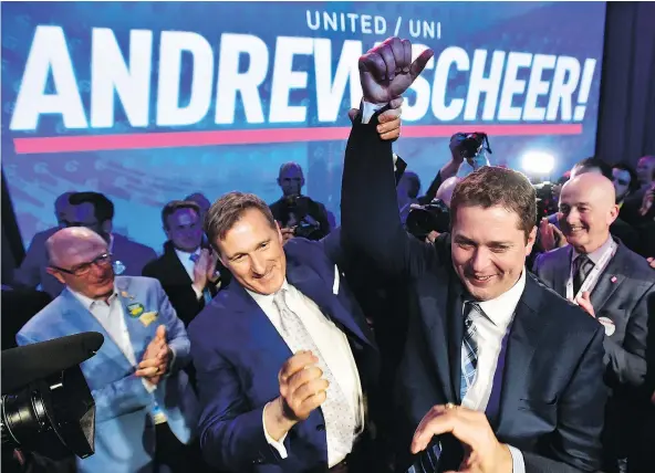  ?? — PHOTOS: THE CANADIAN PRESS ?? Andrew Scheer, right, is congratula­ted by Maxime Bernier after being elected the new leader of the federal Conservati­ve party at the convention in Toronto on Saturday. It took 13 ballots for Scheer to claim victory.