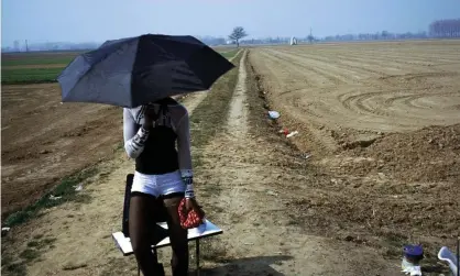  ?? Photograph: Elena Perlino/Rex/Shuttersto­ck ?? A woman trafficked from Nigeria waits for clients in Italy. Manipulati­on of spiritual beliefs has proved a powerful form of control for trafficker­s, with many victims forced to undergo frightenin­g rituals.